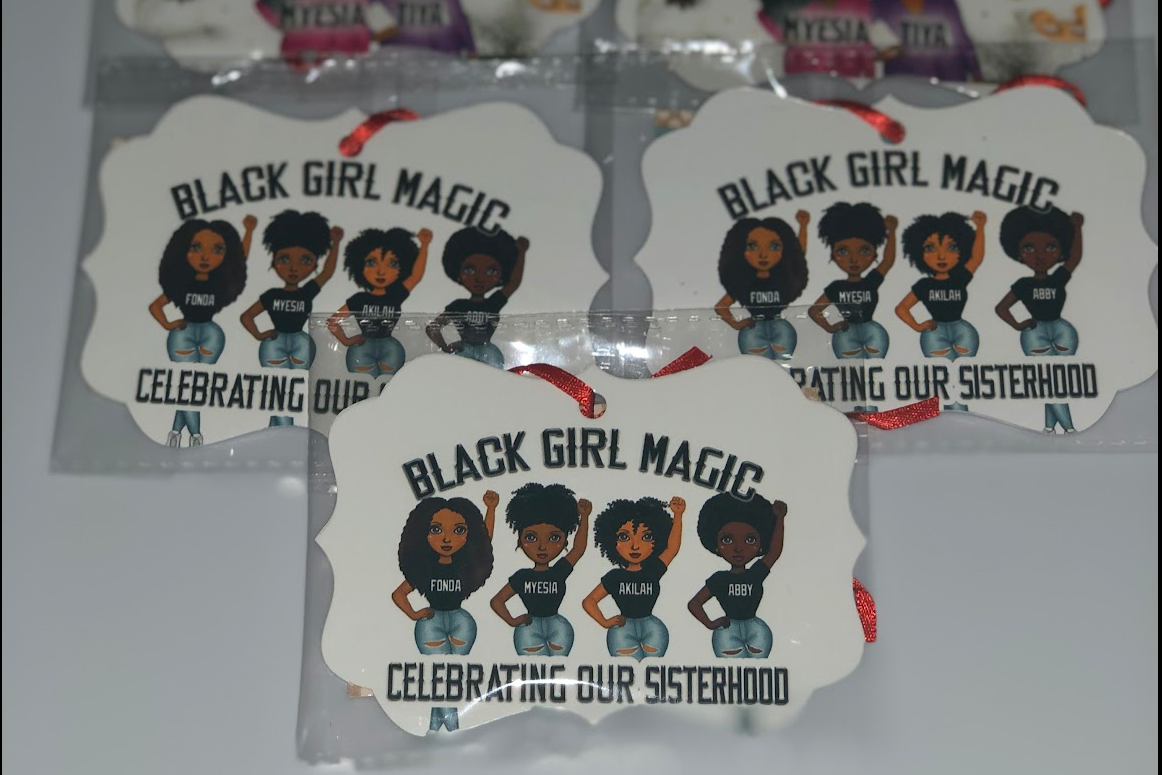 Ornaments with 'Black Girl Magic sisterhood ' design on a white background